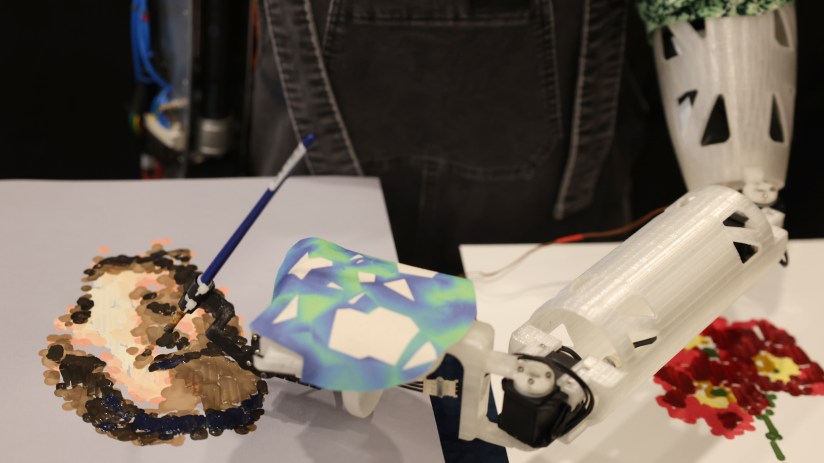 LONDON, ENGLAND - APRIL 04: Ai-Da Robot, an ultra-realistic humanoid robot artist, paints during a press call at The British Library on April 4, 2022 in London, England. Ai-Da will open her solo exhibition LEAPING INTO THE METAVERSE at the Venice Biennale this year curated by Aidan Meller. (Photo by Hollie Adams/Getty Images)