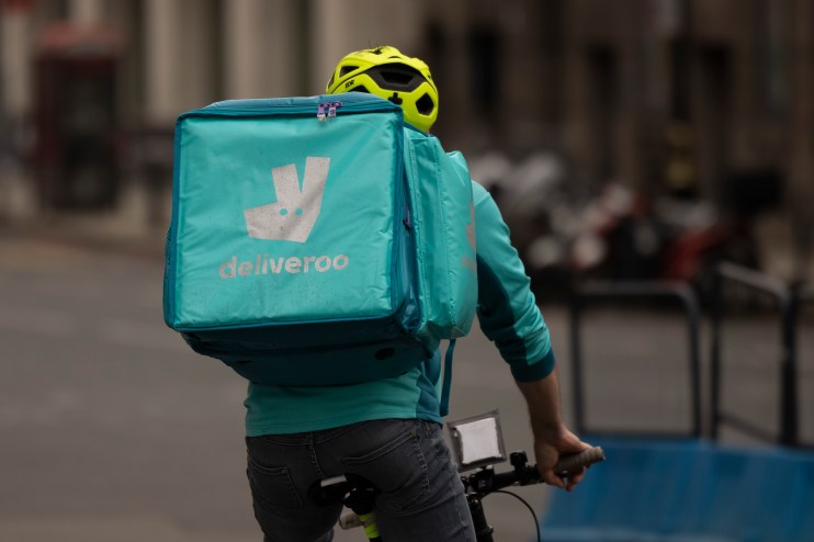 LONDON, ENGLAND - MARCH 31: A Deliveroo rider near Victoria station on March 31, 2021 in London, England. The food-delivery service's market debut was off to a tough start as shares slid significantly from its initial public offering price of &pound;3.90. (Photo by Dan Kitwood/Getty Images)