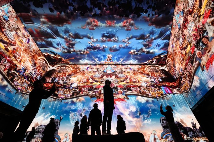 LONDON, ENGLAND - JANUARY 20: People pose for photographs during a photocall for Marco Brambilla&rsquo;s new work "Heaven&rsquo;s Gate" on the 16K screens of the Outernet London display on January 20, 2023 in London, England. Soho's new media and culture location, Outernet London, is one of the most advanced in the world using the latest immersive technology and is part of the ongoing regeneration of Soho. The multi-screen facility covers an area of 23,000 square feet, and allows for 360 degree presentations and displays across four storeys. (Photo by Leon Neal/Getty Images)