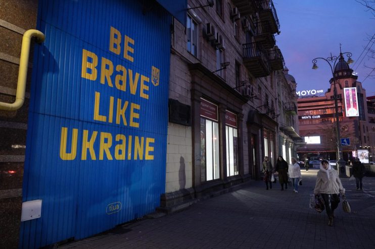 KYIV, UKRAINE - MARCH 05: Pedestrians walk past a sign supporting Ukraine in a downtown shopping area on March 5, 2025 in Kyiv, Ukraine. (Photo by Paula Bronstein / Getty Images)