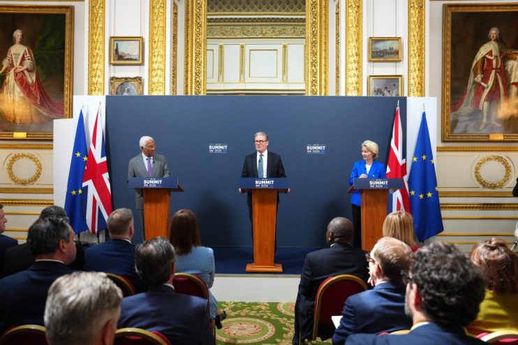 LONDON, ENGLAND - MAY 19: European Council President Antonio Costa (L) and European Commission, Ursula von der Leyen (R) look on as UK Prime Minister Keir Starmer (C) speaks during a press conference at the UK-EU summit at Lancaster House on May 19, 2025 in London, England. Prime Minister Keir Starmer is hosting leaders from the European Union for the first UK-EU Summit since Britain's withdrawal from the EU in January 2020, to discuss plans for resetting the UK's relationship with the bloc. The Labour government has said it will deliver a stronger partnership with the EU, "strengthening our alliances and closing deals in the interests of British people." According to the European Council, the meeting will also be an opportunity for the leaders to reaffirm a joint commitment to peace and security in Europe. (Photo by Carl Court/Getty Images)