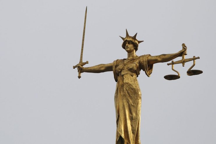 LONDON, ENGLAND - FEBRUARY 16: A statue of the scales of justice stands above the Old Bailey on February 16, 2015 in London, England. (Photo by Dan Kitwood/Getty Images)