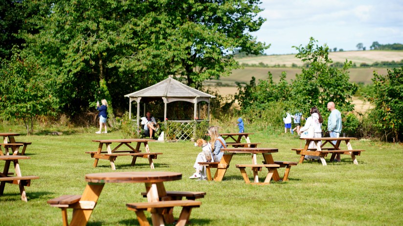 People in the garden of Jeremy Clarkson's pub, The Farmer's Dog, in Oxfordshire. Credit: Ben Birchall/PA Wire