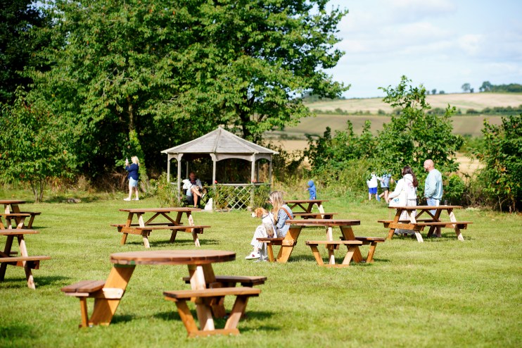 People in the garden of Jeremy Clarkson's pub, The Farmer's Dog, in Oxfordshire. Credit: Ben Birchall/PA Wire