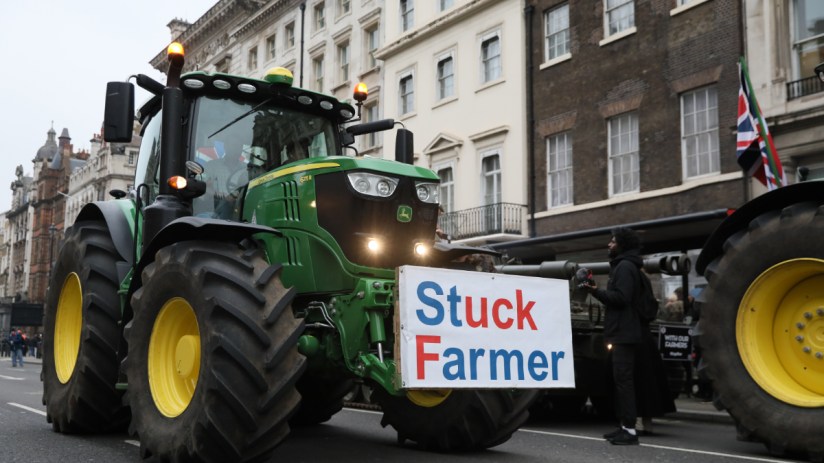 A tractor, carrying the message "Stuck Farmer", drives in Westminster during a Farmers Protest on February 10, 2025 in London, England. Demonstrators gather in central London to protest against changes to inheritance tax rules for land ownership for farmers. (Photo by Alishia Abodunde/Getty Images)