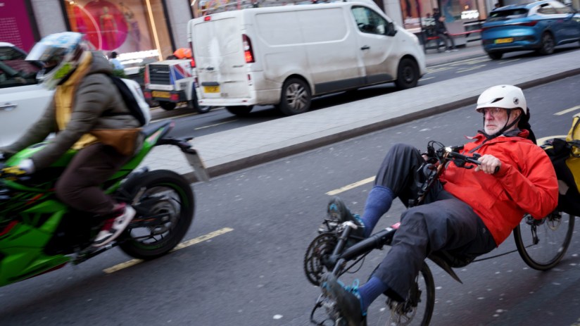 Motorcycle and recumbent bicycle in London road.