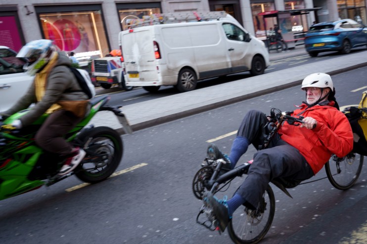 Motorcycle and recumbent bicycle in London road.