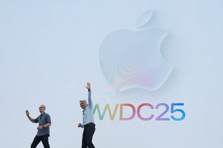 CUPERTINO, CALIFORNIA - JUNE 09: Apple CEO Tim Cook (L) and Senior Vice President of Software Engineering Craig Federighi greet the audience during the Apple Worldwide Developers Conference (WWDC) on June 09, 2025 in Cupertino, California. Cook kicked off the annual Apple WWDC conference, which runs through June 13. Apple is expected to announce design and fuctionality updates to the operating system of its various products. (Photo by Justin Sullivan/Getty Images)