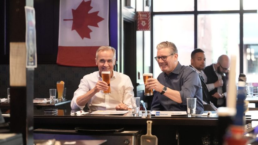 JUNE 14: Prime Minister Sir Keir Starmer and Prime Minister of Canada Mark Carney drinking beer whilst watching a ice hockey game on television between Edmonton Oilers v Florida Panthers at Royal Oak pub ahead of the G7 leaders' summit on June 14, 2025 in Ottawa, Canada. (Photo by Stefan Rousseau - Pool/Getty Images)