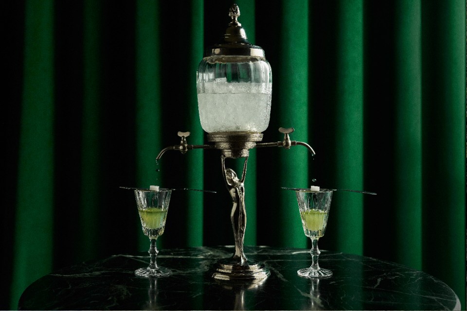 A traditional absinthe fountain, which dissolves a sugar cube with icy water, turning the spirit cloudy