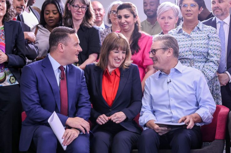 LONDON, ENGLAND - JULY 03: Britain's Health Secretary Wes Streeting (L), Britain's Chancellor of the Exchequer Rachel Reeves (C), and Britain's Prime Minister Keir Starmer react during a visit to the Sir Ludwig Guttman Health & Wellbeing Centre on July 03, 2025 in London, England. Keir Starmer and Wes Streeting launch the government's 10-Year Health Plan, outlining how the Labour government will deliver the Plan for Change mission to rebuild the NHS through three key reform shifts: analogue to digital, hospital to community, and sickness to prevention. (Photo by Jack Hill - WPA Pool/Getty Images)