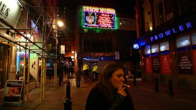 LONDON, ENGLAND - JANUARY 19: A woman walks past the Raymond Revuebar in Soho on January 19, 2015 in London, England. A growing number of campaigners, including Stephen Fry, are pushing developers and representatives of Westminster Council to preserve the area's unique identity, which they fear is being lost as the area is gradually redeveloped. (Photo by Carl Court/Getty Images)