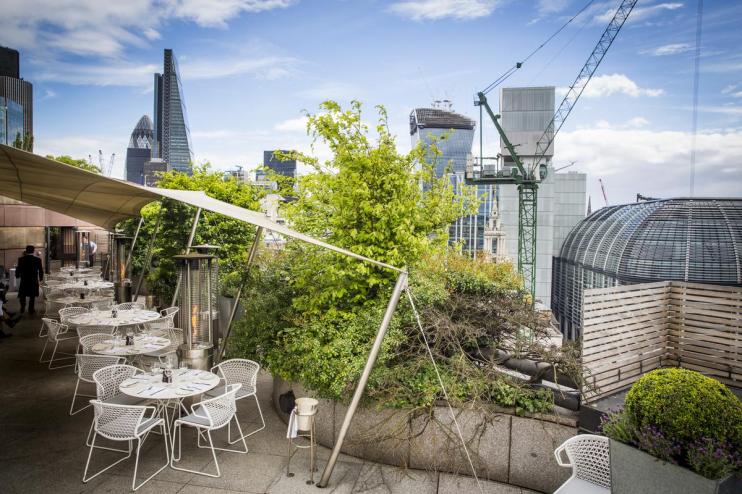 Coq dArgent rooftop dining area with cityscape views, iconic restaurant known for French cuisine in Square Miles No 1 Poultry