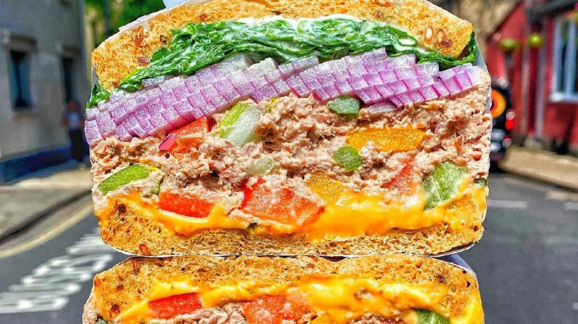 City workers in queue outside popular sandwich shop in Square Mile, eager for lunch break with best sandwiches in the city