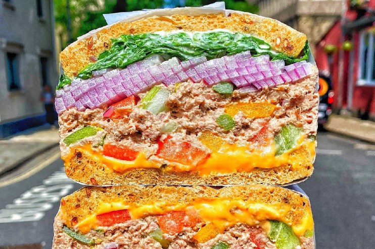 City workers in queue outside popular sandwich shop in Square Mile, eager for lunch break with best sandwiches in the city