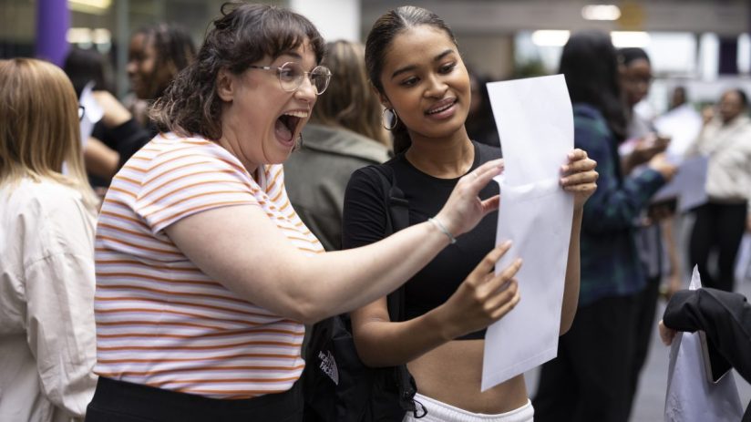 LONDON, UNITED KINGDOM - AUGUST 18: Student Maya Adams (R) of Canada Academy in Southwark opens her A-Level results with her drama teacher Ms Young on August 18, 2022 in London, United Kingdom. This is the first year since 2019 that A-level results are based on public exams, after pandemic-related disruptions in 2020 and 2021 led to A-level results relying on teachers' assessments. A-level grades are expected to be lower this year on average. (Photo by Dan Kitwood/Getty Images)