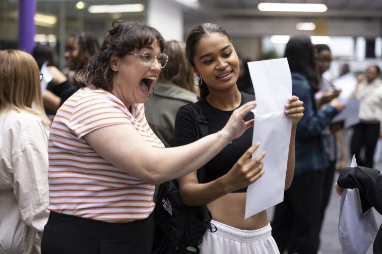 LONDON, UNITED KINGDOM - AUGUST 18: Student Maya Adams (R) of Canada Academy in Southwark opens her A-Level results with her drama teacher Ms Young on August 18, 2022 in London, United Kingdom. This is the first year since 2019 that A-level results are based on public exams, after pandemic-related disruptions in 2020 and 2021 led to A-level results relying on teachers' assessments. A-level grades are expected to be lower this year on average. (Photo by Dan Kitwood/Getty Images)