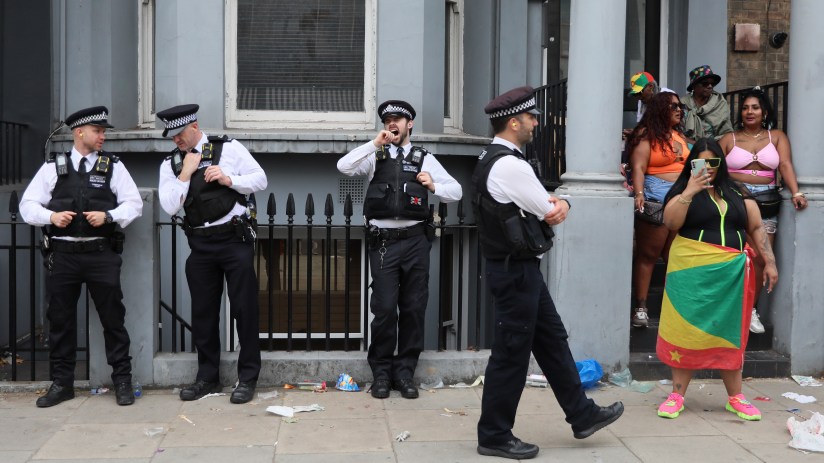 LONDON, ENGLAND - AUGUST 25: A police officer yawns as he stands amongst other officers while revellers attend Notting Hill Carnival on August 25, 2024 in London, United Kingdom. Sunday is known to be family-friendly with the Children's Parade taking place culminating in the children's mas. The Notting Hill Carnival celebrating Caribbean culture has taken place over the summer bank holiday most years since 1966. (Photo by Alishia Abodunde/Getty Images)