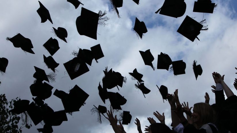 University graduates throw their mortarboards in the air (Photo by Christopher Furlong/Getty Images)