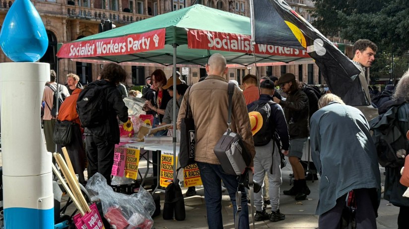 People gather at the Socialist Workers Party tent set up ahead of the March Against Fascism