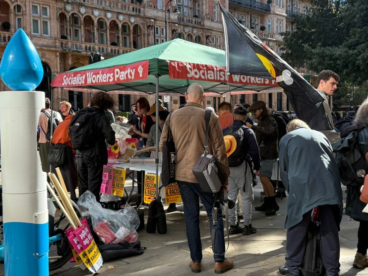 People gather at the Socialist Workers Party tent set up ahead of the March Against Fascism