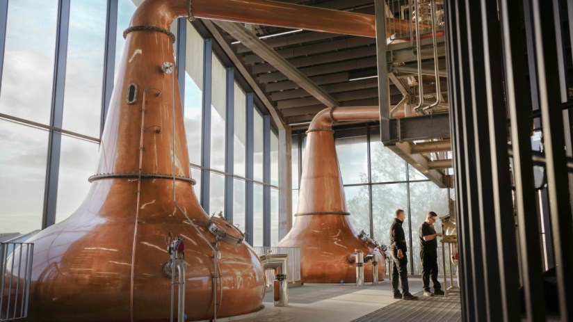 Distillery workers take the cut at the spirit safe at port ellen distillery collecting whisky from the stills after 40 years of closure
