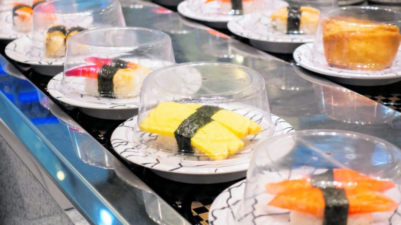 Sushi on conveyor belt in a Thailand restaurant. Shushi Go Round is a famous form of fast food in Asia, also known as sushi train.