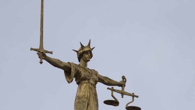 LONDON, ENGLAND - JANUARY 19: A statue of the Scales of Justice stands above the Old Bailey on January 19, 2021 in London, England. Criminal watchdogs representing England and Wales have expressed concern over the backlog of cases, caused by the Coronavirus pandemic. Figures have revealed that the backlog of unheard cases in the crown courts has reached 54,000. (Photo by Dan Kitwood/Getty Images)