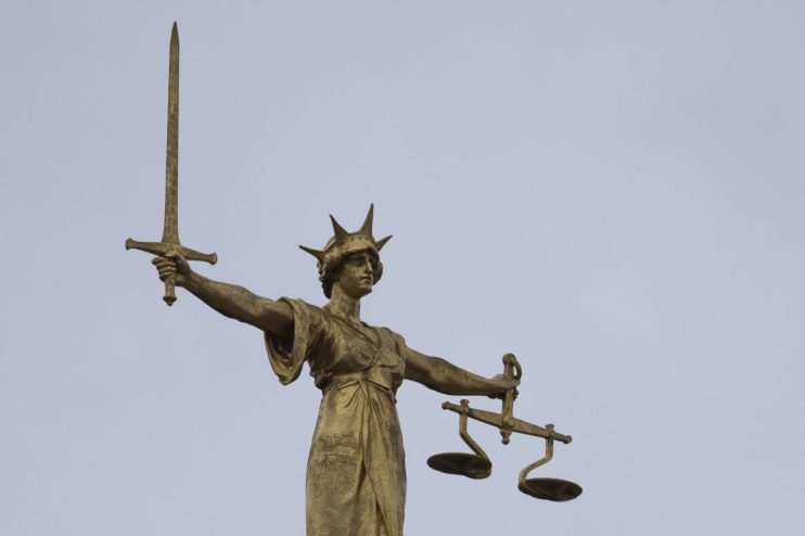 LONDON, ENGLAND - JANUARY 19: A statue of the Scales of Justice stands above the Old Bailey on January 19, 2021 in London, England. Criminal watchdogs representing England and Wales have expressed concern over the backlog of cases, caused by the Coronavirus pandemic. Figures have revealed that the backlog of unheard cases in the crown courts has reached 54,000. (Photo by Dan Kitwood/Getty Images)