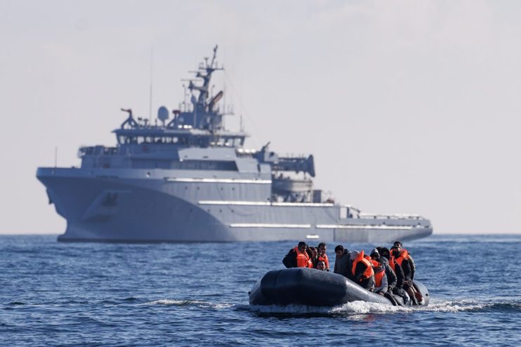 ENGLISH CHANNEL - MARCH 06: An inflatable dinghy carrying migrants is escorted by a French Warship across the English Channel towards British Waters on March 06, 2024 in the English Channel. According to official figures 401 migrants arrived in the UK by small boat on Monday, the busiest day of the year so far for Channel crossings. This brings the provisional total number of UK arrivals so far this year to 2,983. Government data indicates this is more than the 2,953 logged this time last year and surpasses the running totals documented between January 1 and March 4 each year since current records began in 2018. (Photo by Dan Kitwood/Getty Images) (Photo by Dan Kitwood/Getty Images)