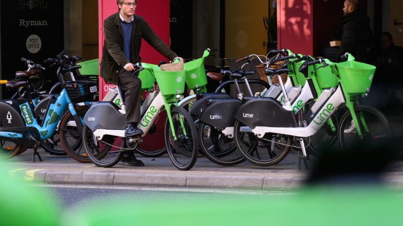 LONDON, ENGLAND - NOVEMBER 26: A man hires a Lime rental e-bike on November 26, 2024 in London, England. Transport For London may take enforcement action against companies providing e-scooters and e-bikes to tackle poorly parked vehicles that cause access or safety issues. Transport for London has allocated around &pound;1million to allow boroughs to create 7,500 new parking spaces, while also creating 800 parking bays along the red route network. Rental companies who fail to enforce stricter parking regulations may see their e-bikes confiscated. (Photo by Leon Neal/Getty Images)