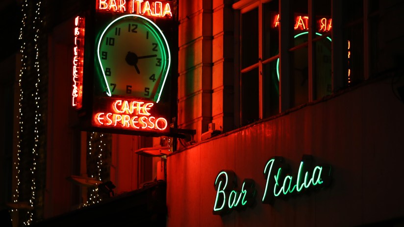 London diners enjoying late-night meals in a bustling restaurant, highlighting the debate over the citys dining trends.