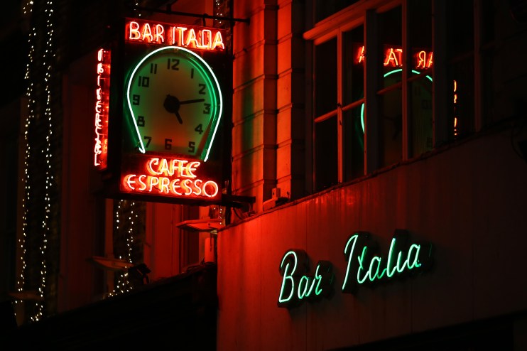 London diners enjoying late-night meals in a bustling restaurant, highlighting the debate over the citys dining trends.