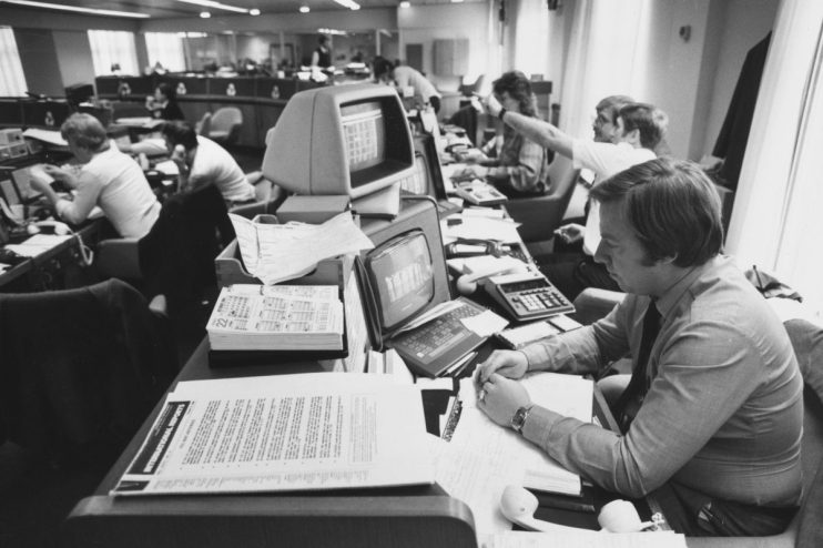 Staff at work at computer screens in a modern office in Canada, circa 1990. (Photo by Steve Eason/Hulton Archive/Getty Images)
