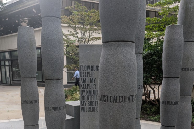 Gilt of Cain sculpture in Fen Court depicting biblical themes of jealousy and violence with urban cityscape backdrop.