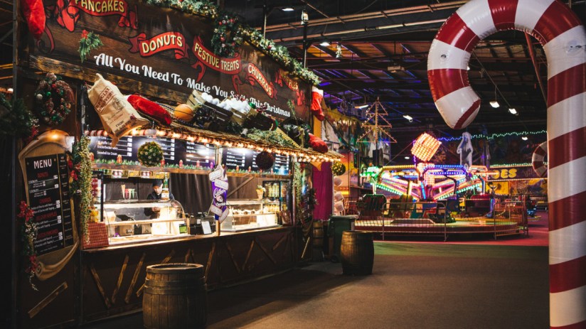 Winter Funland 2018 festive amusement park with families enjoying rides and holiday decorations in a snowy landscape