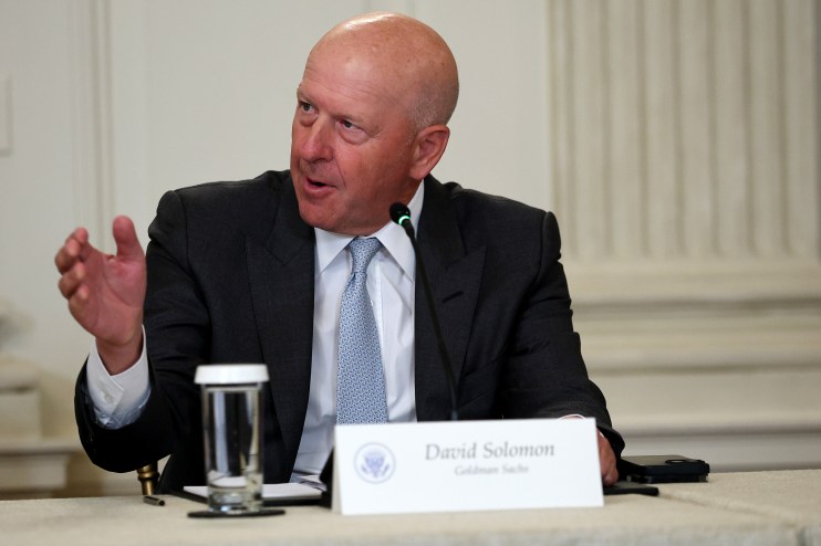 David Solomon speaking at a business conference, dressed in a suit, addressing a professional audience with a focused expr...