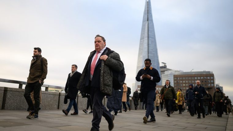 LONDON, UNITED KINGDOM - JANUARY 31: The Shard is seen on the horizon as commuters cross London Bridge during the morning rush hour on January 31, 2023 in London, United Kingdom. The IMF reports that the UK economy will contract by 0.6% in 2023, as opposed to the previous prediction it might grow, and will perform worse than many other advanced economies, including Russia.The cost of living continues to hit households with grocery inflation for the first four weeks of 2023 rising to 16.7% which would add a further £788 per year to family food bills. (Photo by Leon Neal/Getty Images)