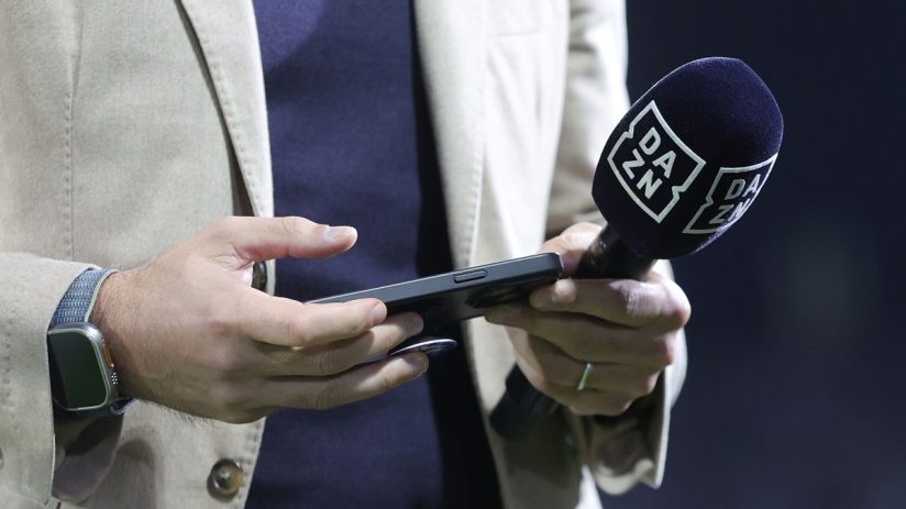 Breaking news event with journalists gathered, microphones, and cameras capturing an official statement at a press conference