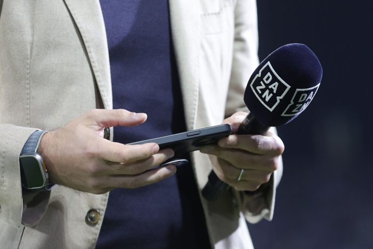Breaking news event with journalists gathered, microphones, and cameras capturing an official statement at a press conference