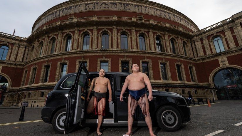 DECEMBER 04: Sumo Wrestlers Kitanowaka Daisuke and Fukutsuumi Akira of Japan pose with a London Black Cab following The Grand Sumo Tournament press conference at Royal Albert Hall on December 04, 2024 in London, England. (Photo by Ryan Pierse/Getty Images)