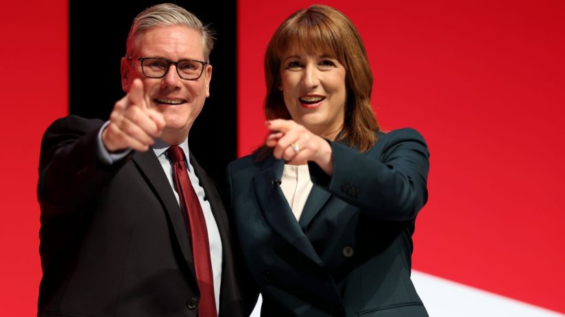 LIVERPOOL, ENGLAND - SEPTEMBER 29: Prime Minister Keir Starmer and Chancellor of the Exchequer Rachel Reeves react on stage during day two of the Labour Party conference at ACC Liverpool on September 29, 2025 in Liverpool, England. The Labour Conference is being held against a vastly different backdrop to last year when the party had swept to power in a landslide general election victory. A year on and polling shows three quarters of Britons (74-77%) say they have little to no trust in the party on the cost of living, immigration, taxation, managing the economy, representing people like them, or keeping its promises. (Photo by Jeff J Mitchell/Getty Images)