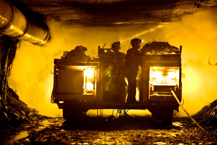 Two coal miners in mine shaft (Credit: Tyler Tableford via Getty)