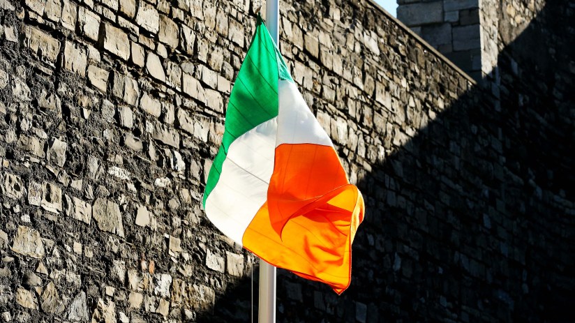 Irish flag waving against a clear blue sky, representing national pride and unity in a general news context.