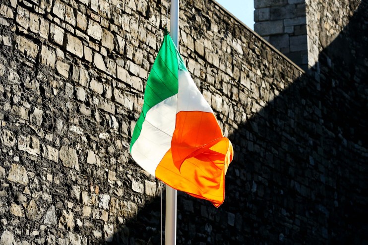 Irish flag waving against a clear blue sky, representing national pride and unity in a general news context.