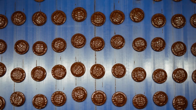 Jaffa Cakes arranged on a table showcasing their distinctive layers of sponge, orange-flavored jelly, and chocolate coating