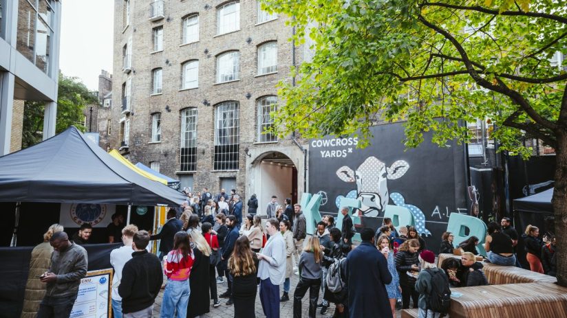 Busy lunch market at KERB Cowcross Yard in Farringdon, featuring diverse food stalls and vibrant crowd enjoying meals