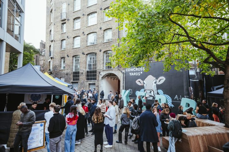 Busy lunch market at KERB Cowcross Yard in Farringdon, featuring diverse food stalls and vibrant crowd enjoying meals