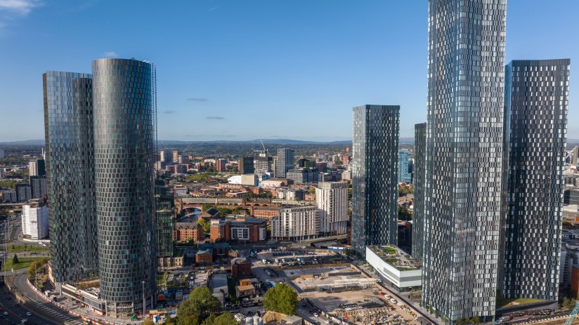 Manchester cityscape featuring iconic architecture and bustling streets, highlighting urban development and vibrant city l...