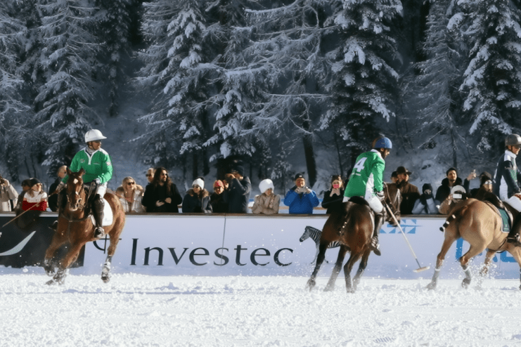 Snow Polo World Cup action with players and horses on a snowy field, showcasing dynamic competition and winter sports eleg...
